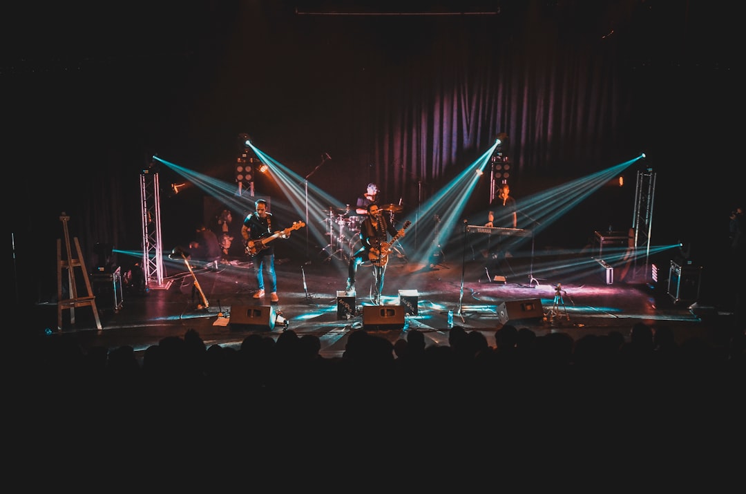 people-standing-on-stage-with-lights-turned-on-during-night-time-uqvgxnh6vbg